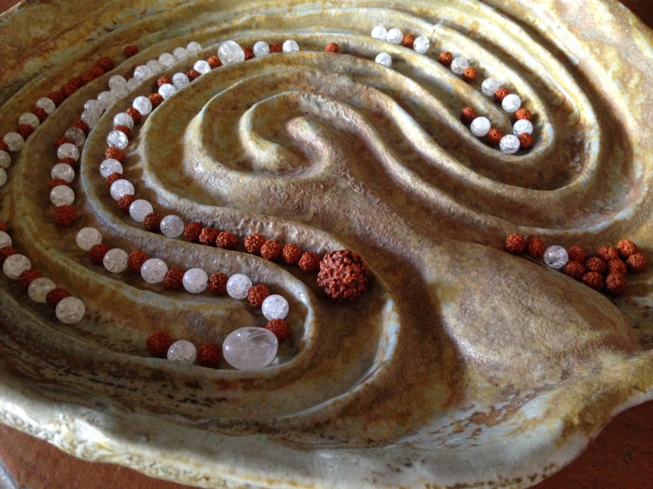 Arranging stones and seeds on a labyrinth place before stringing together... this allows me to visualise how the finished mala will look like, and lays out the 'path' I will follow when knotting the mala.